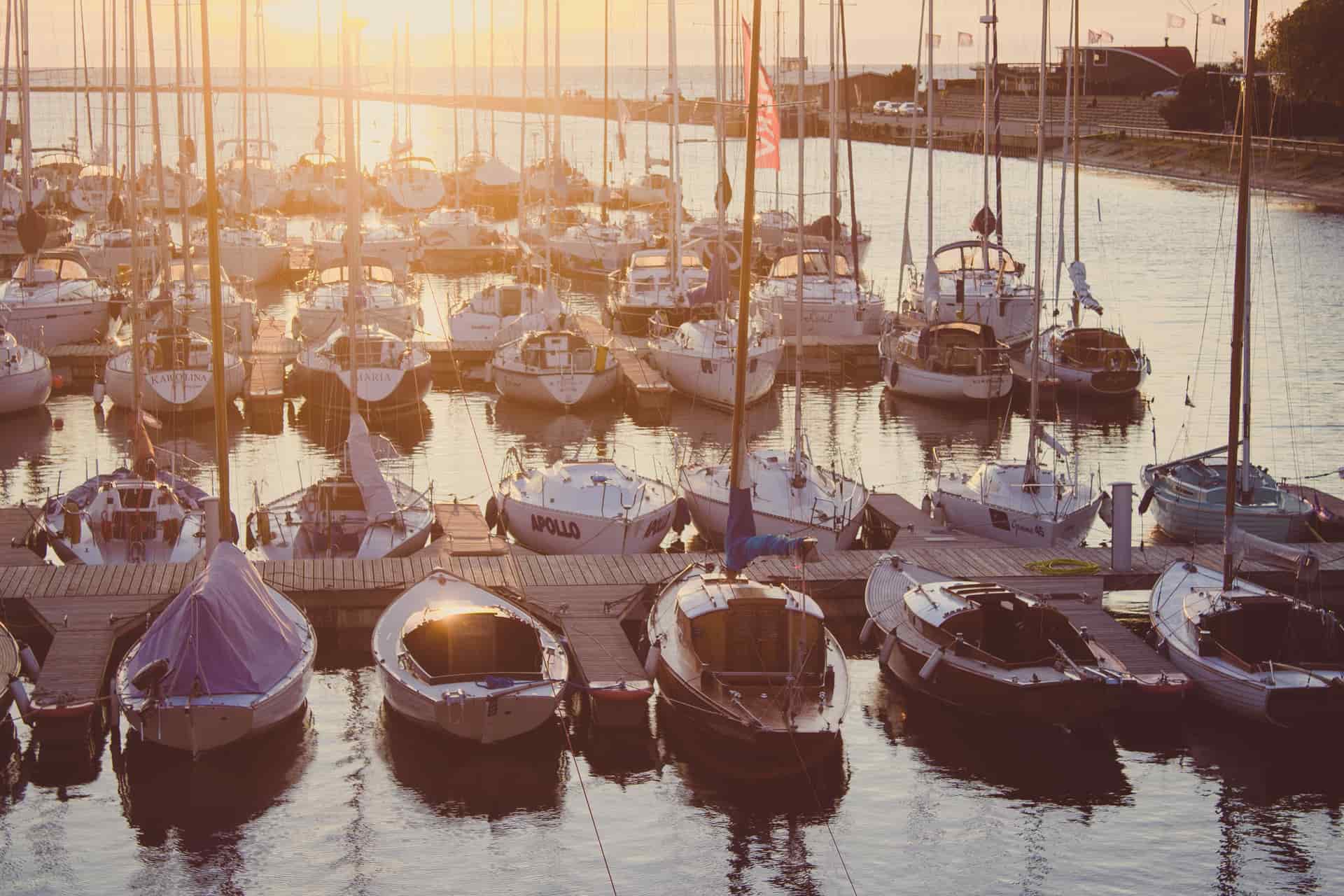 A wooden pier beside sailing boats on the water